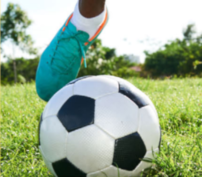 a foot kicking a soccer ball